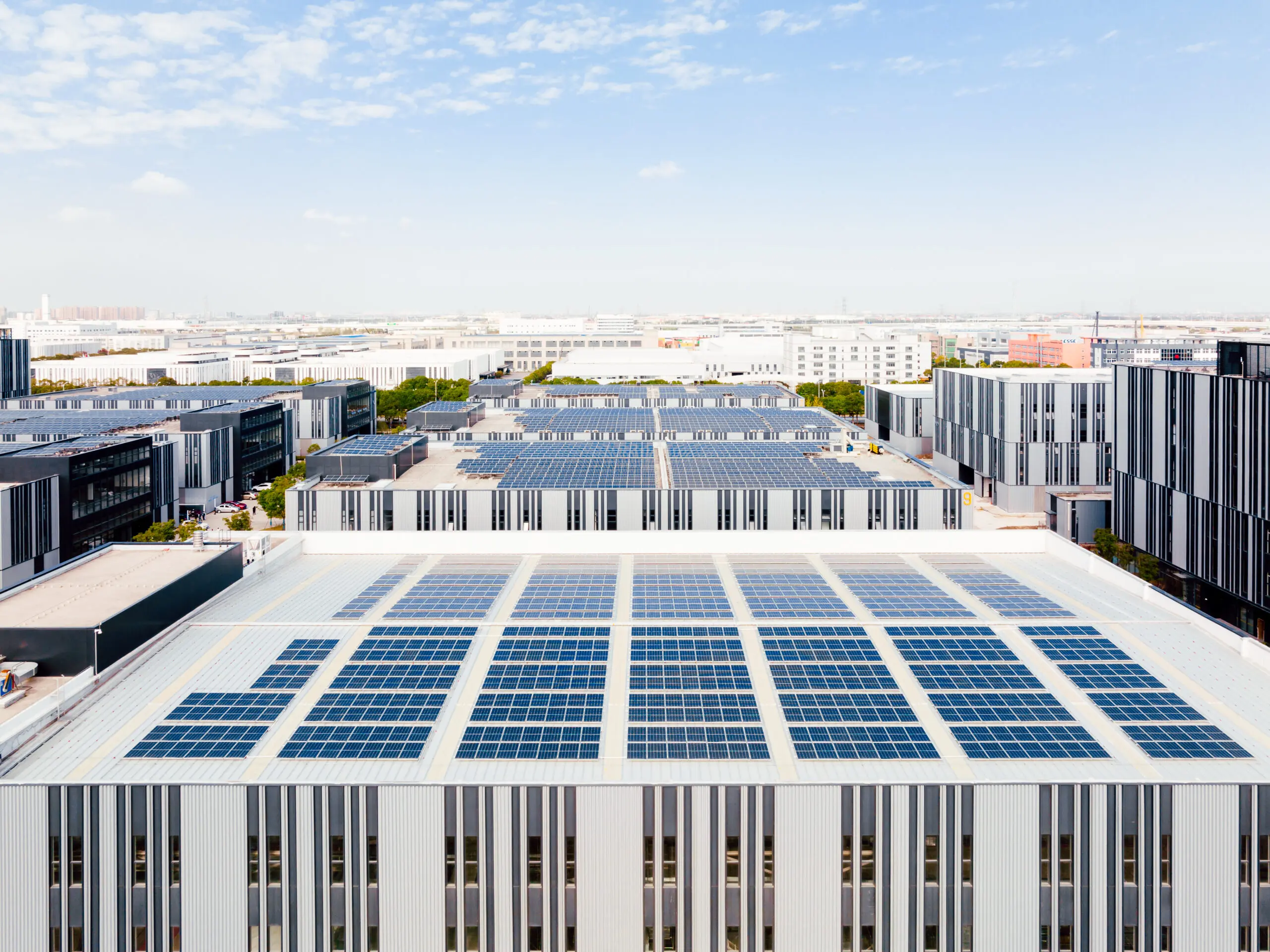 Aerial view of solar panels on factory roof. Blue shiny solar photo voltaic panels system product. Aerial view of solar panels on factory roof.